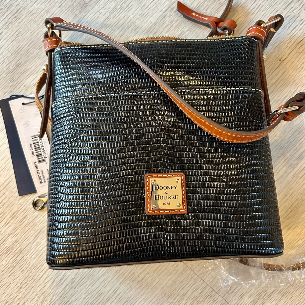 Dooney & Bourke NWT midnight blue letter Carrier crossbody bag. 8x9”